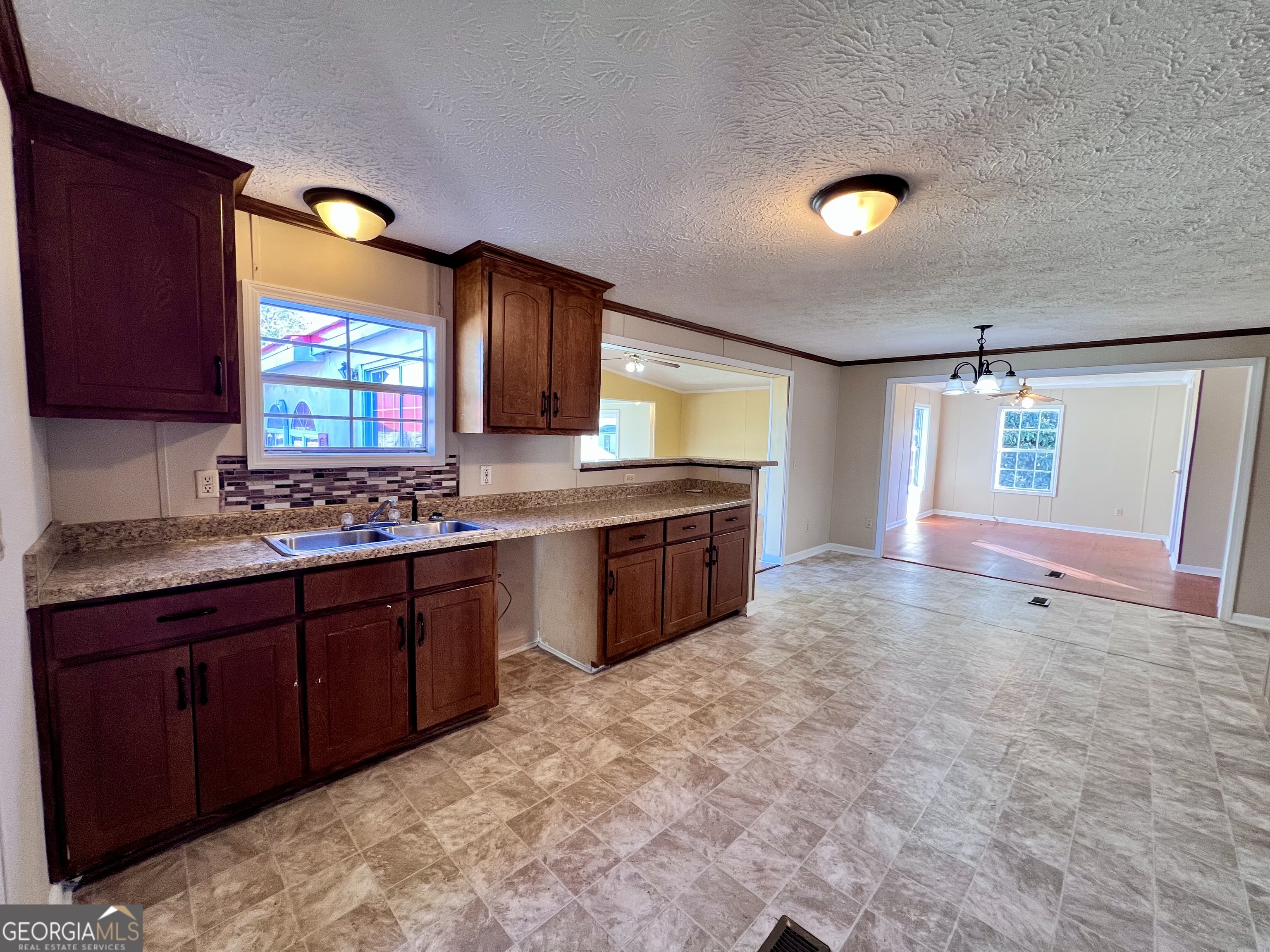 103 Henderson Springs Road Elko, GA 31025 - Photo 6 of 33 a large kitchen with kitchen island granite countertop a stove a sink dishwasher and a refrigerator