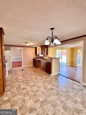 a view of a kitchen with a sink and cabinets