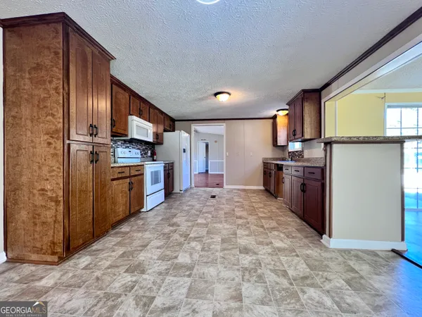 a large kitchen with cabinets and stainless steel appliances