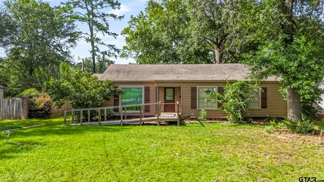a view of an house with backyard space and garden
