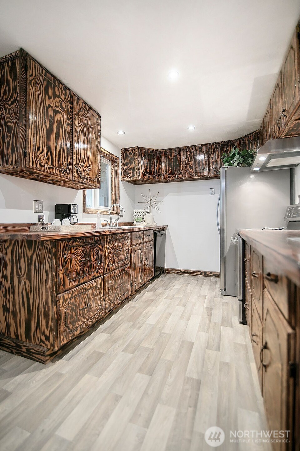 140 Rodgers Road Silverlake, WA 98645 - Photo 11 of 35 a kitchen with stainless steel appliances granite countertop a sink a stove and a wooden floors
