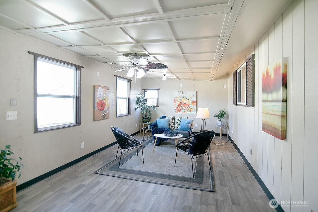 140 Rodgers Road Silverlake, WA 98645 - Photo 14 of 35 a dining room with wooden floor a chandelier a glass table and chairs
