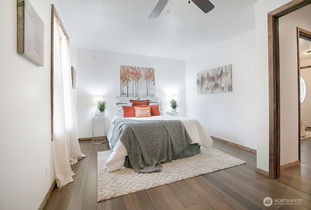 140 Rodgers Road Silverlake, WA 98645 - Photo 18 of 35 a bedroom with a bed and wooden floor