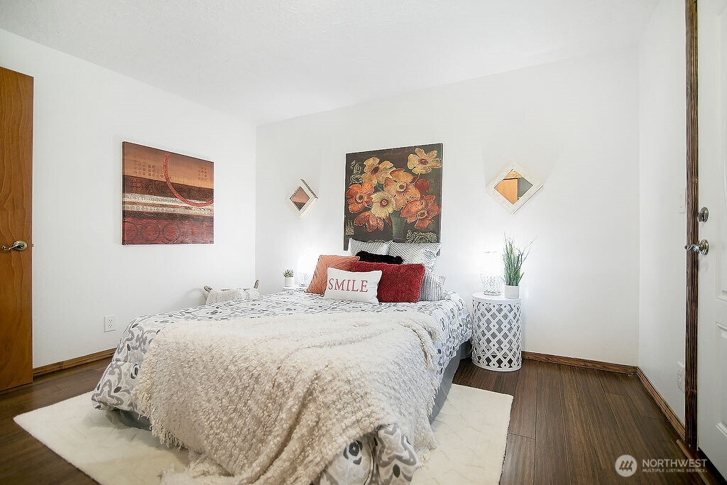 140 Rodgers Road Silverlake, WA 98645 - Photo 21 of 35 a bedroom with a bed and wooden floor