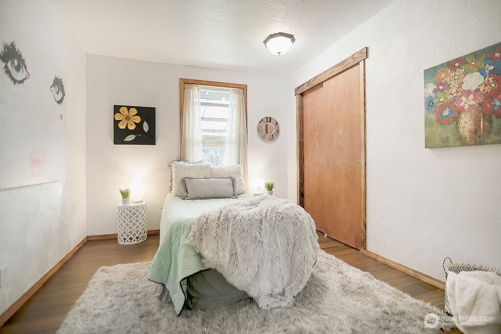 140 Rodgers Road Silverlake, WA 98645 - Photo 23 of 35 a bedroom with a bed and wooden floor