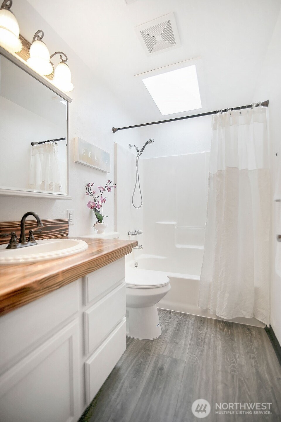 140 Rodgers Road Silverlake, WA 98645 - Photo 25 of 35 a bathroom with a double vanity sink a toilet and a shower
