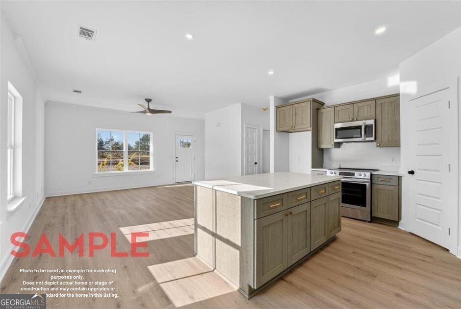 14 Casey Road Northeast Townsend, GA 31331 - Photo 3 of 12 a kitchen that has a lot of cabinets in it and wooden floor