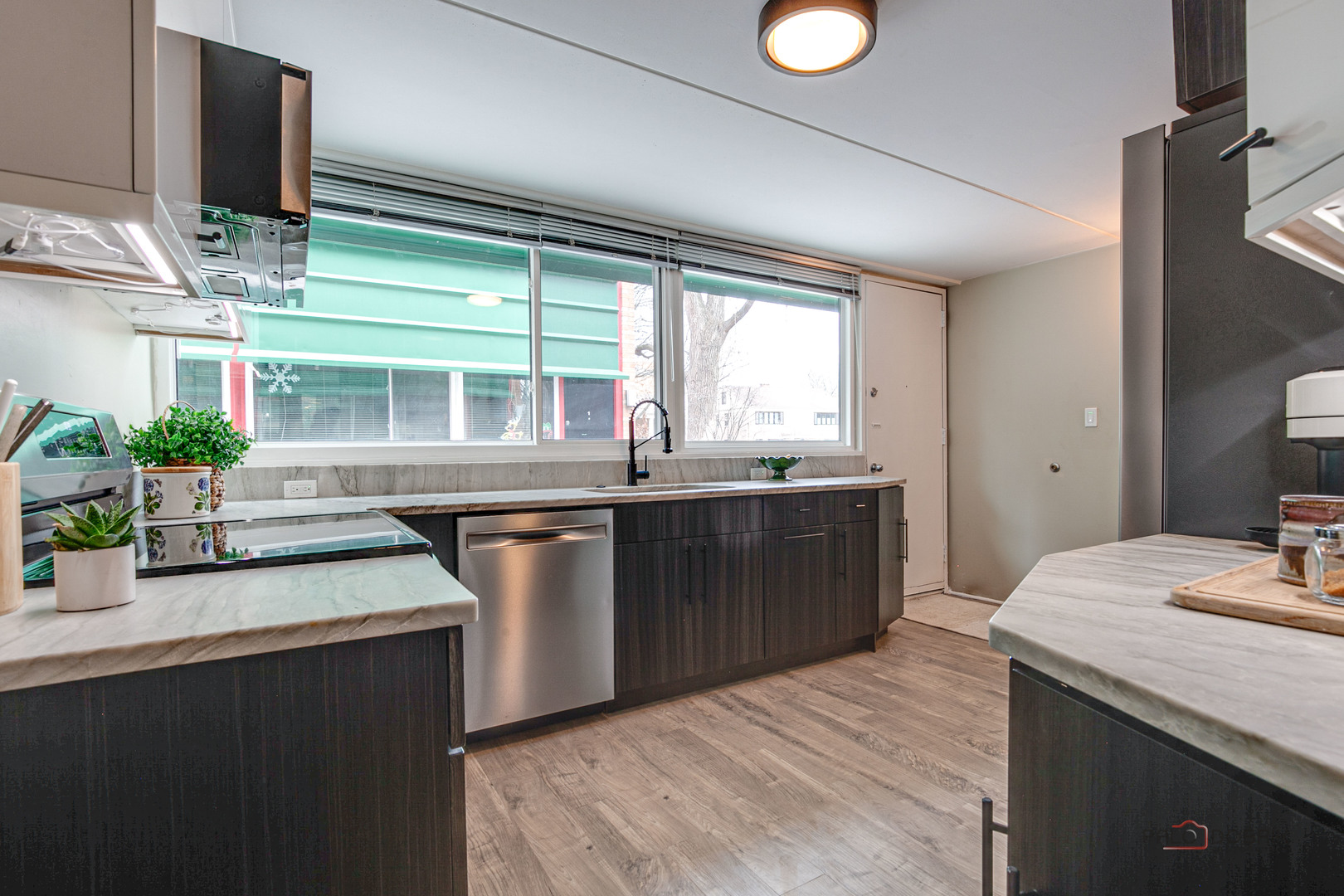 840 Michigan Avenue, Unit 9 Evanston, IL 60202 - Photo 9 of 27 a kitchen with stainless steel appliances granite countertop a sink a stove and a wooden floors