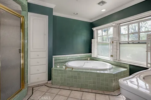 a bedroom with a bed and a table chair