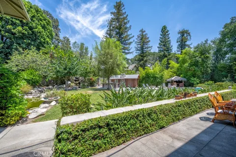 a view of a house with swimming pool and porch with furniture
