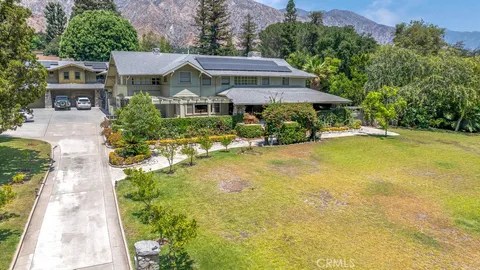 a front view of a house with yard and swimming pool
