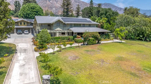 a front view of a house with yard and swimming pool