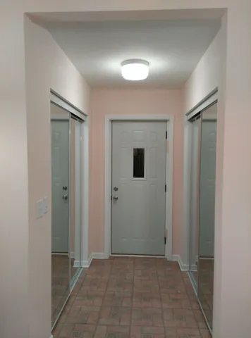 a view of a hallway to rooms