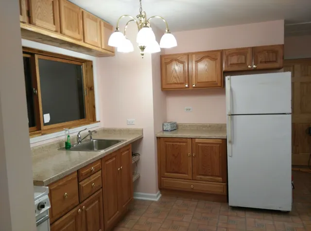 a kitchen with a sink and refrigerator