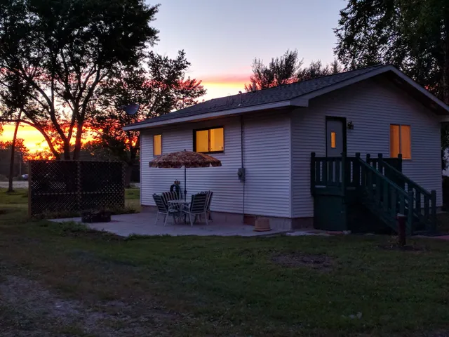 a front view of house with yard and outdoor seating