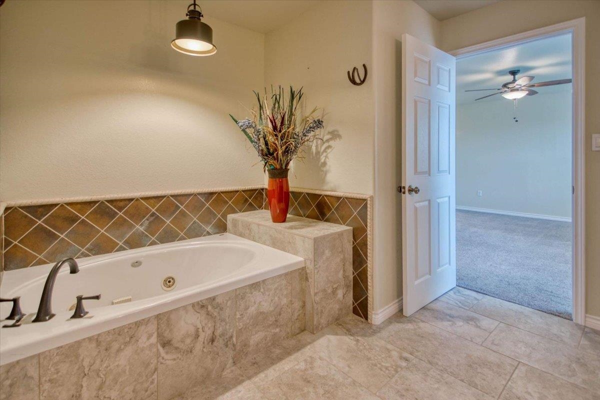 243 East Flag Creek Ranch Road Llano, TX 78643 - Photo 22 of 29 a bathroom with a bathtub and a shower