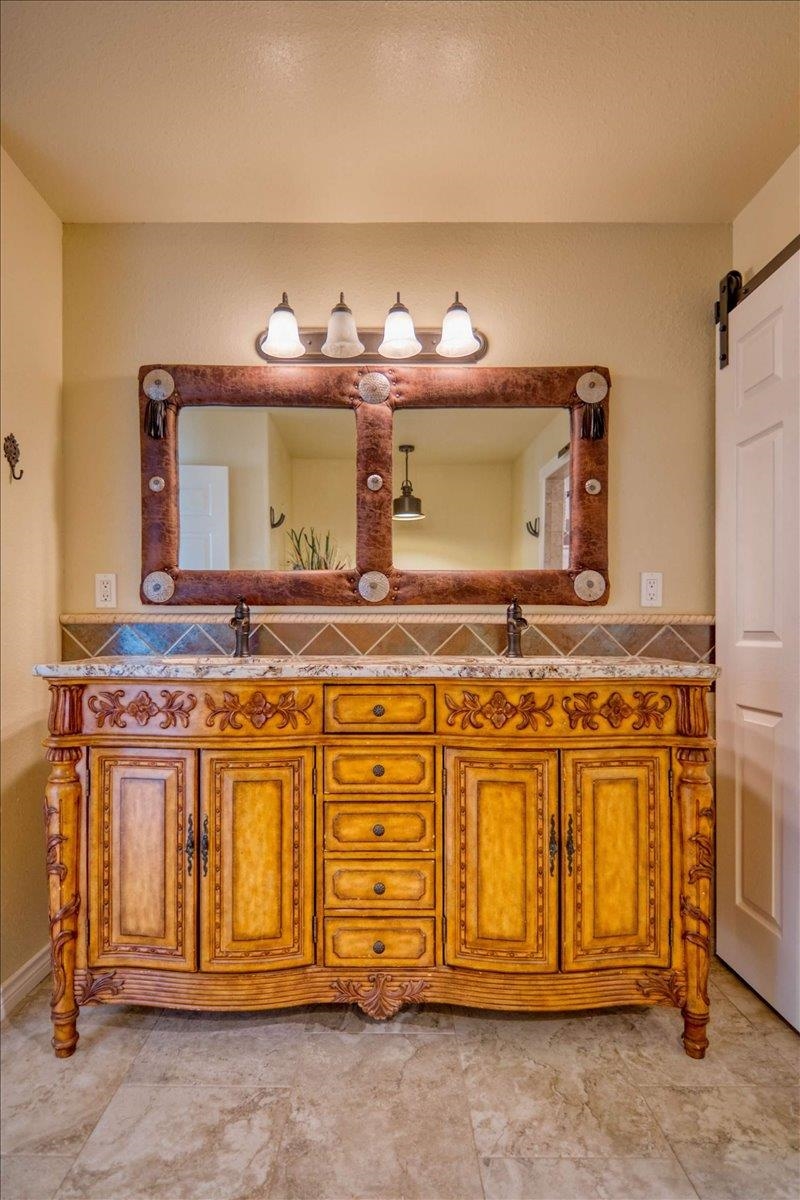 243 East Flag Creek Ranch Road Llano, TX 78643 - Photo 25 of 29 a bathroom with a sink and a mirror