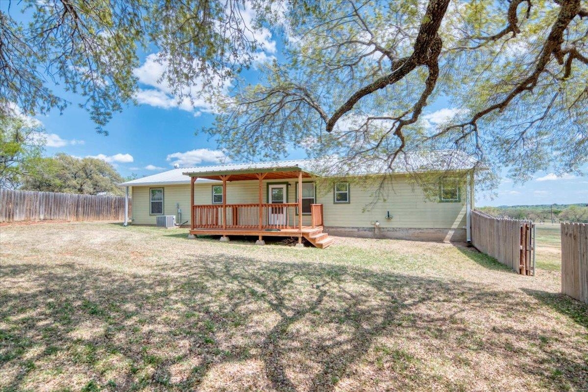 243 East Flag Creek Ranch Road Llano, TX 78643 - Photo 27 of 29 a view of a house with a yard and sitting area