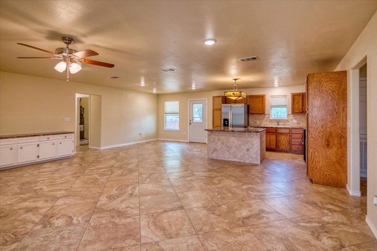 243 East Flag Creek Ranch Road Llano, TX 78643 - Photo 4 of 29 a view of a kitchen with a sink and a refrigerator