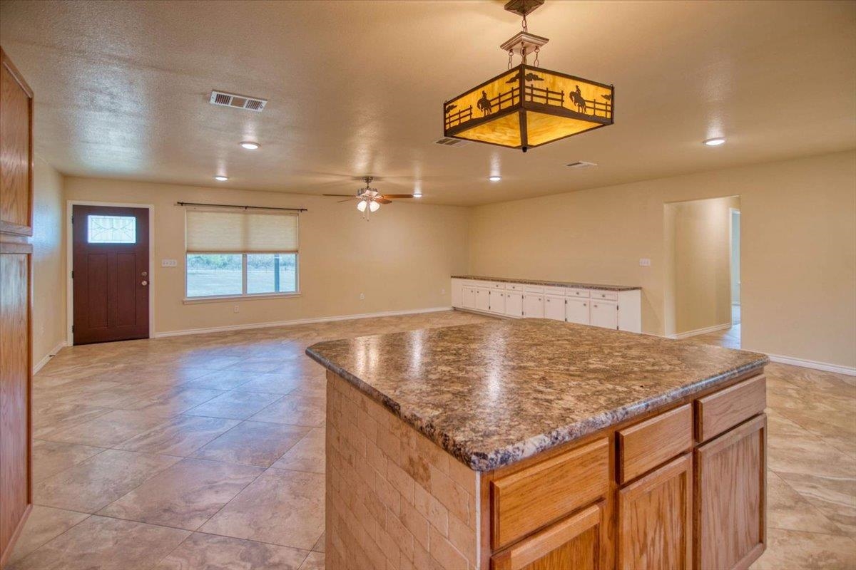 243 East Flag Creek Ranch Road Llano, TX 78643 - Photo 8 of 29 a kitchen with a sink a chandelier and wooden floor