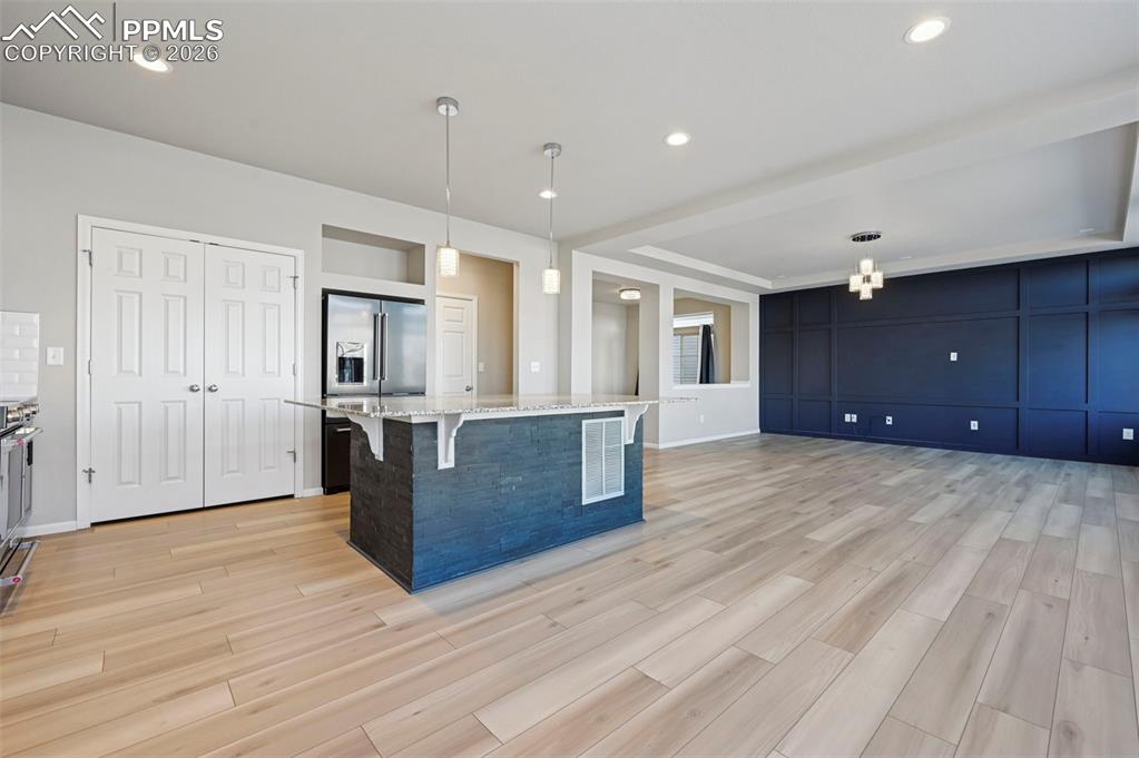 6640 Backcountry Loop Colorado Springs, CO 80927 - Photo 11 of 49 a view of kitchen with cabinets and wooden floor