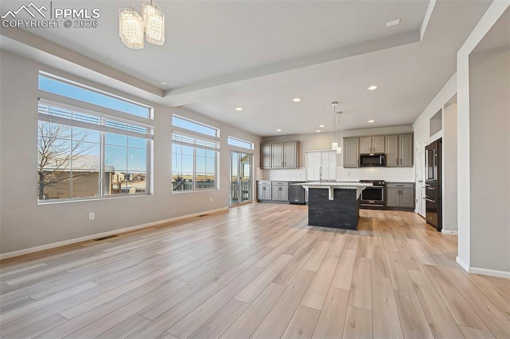 6640 Backcountry Loop Colorado Springs, CO 80927 - Photo 13 of 49 a large space with kitchen view and living room view