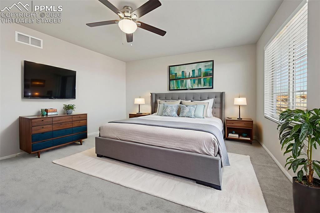 6640 Backcountry Loop Colorado Springs, CO 80927 - Photo 23 of 49 a bedroom with a bed and a flat screen tv