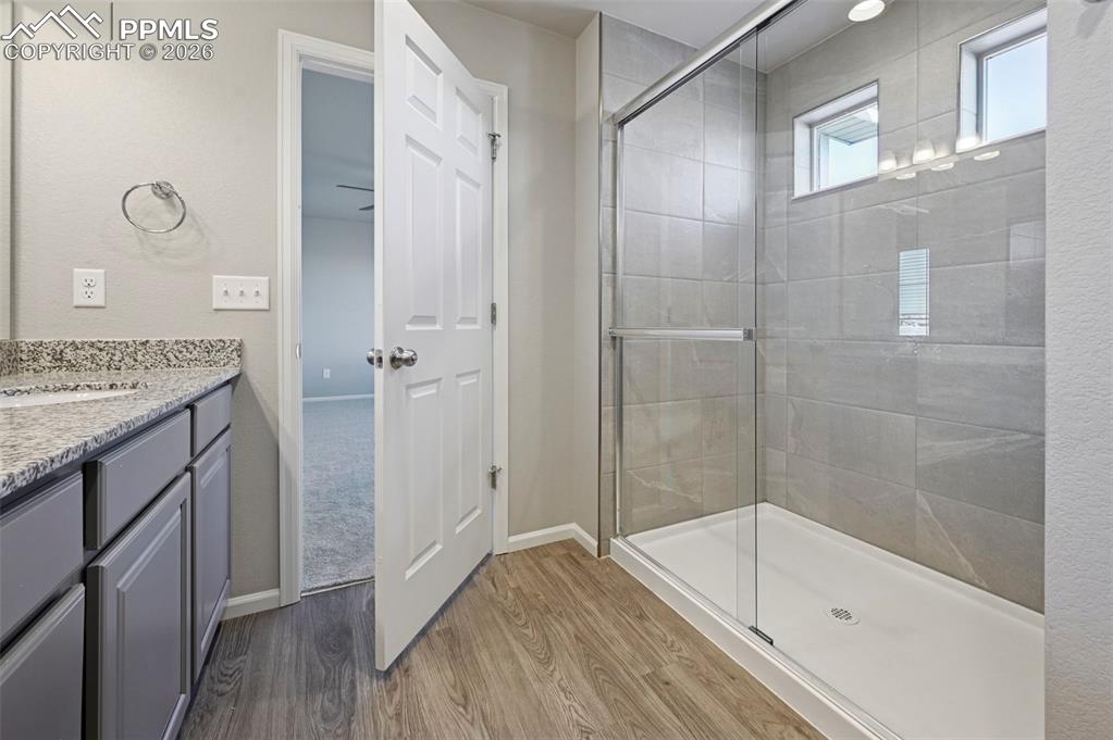 6640 Backcountry Loop Colorado Springs, CO 80927 - Photo 27 of 49 a bathroom with a tub shower vanity and a sink
