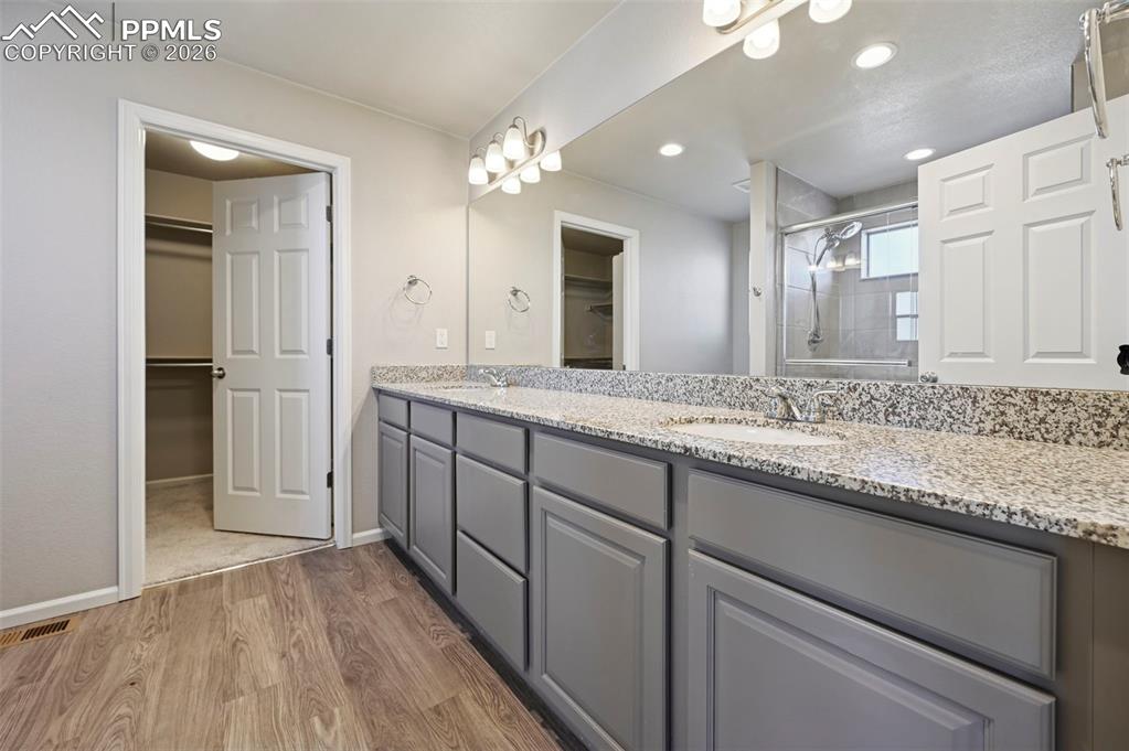 6640 Backcountry Loop Colorado Springs, CO 80927 - Photo 28 of 49 a bathroom with a granite countertop double vanity sink and mirror
