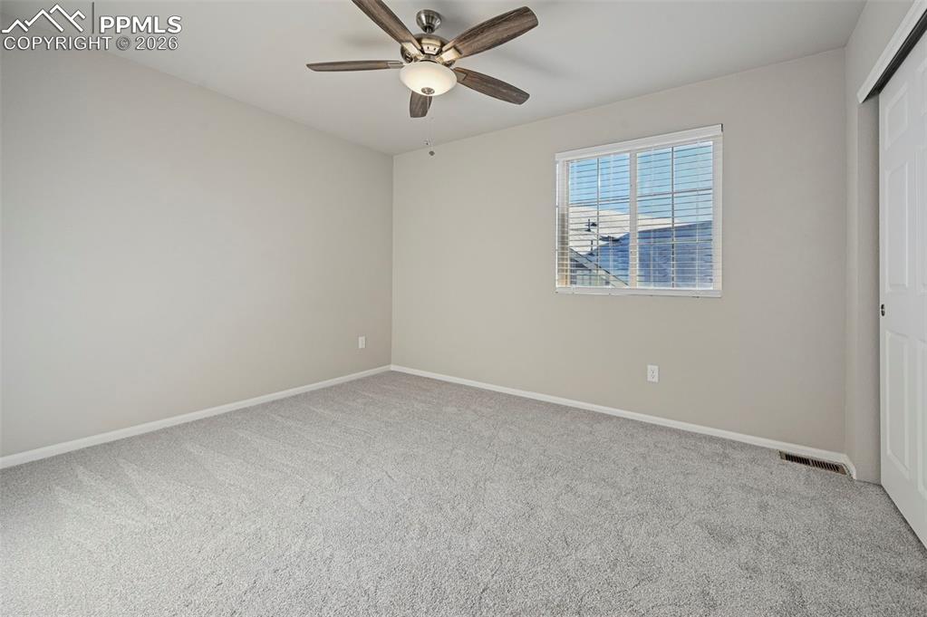 6640 Backcountry Loop Colorado Springs, CO 80927 - Photo 30 of 49 an empty room with windows and fan