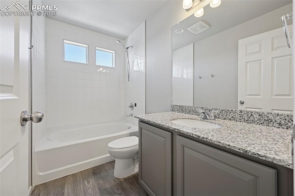 6640 Backcountry Loop Colorado Springs, CO 80927 - Photo 32 of 49 a bathroom with a granite countertop sink a toilet and shower