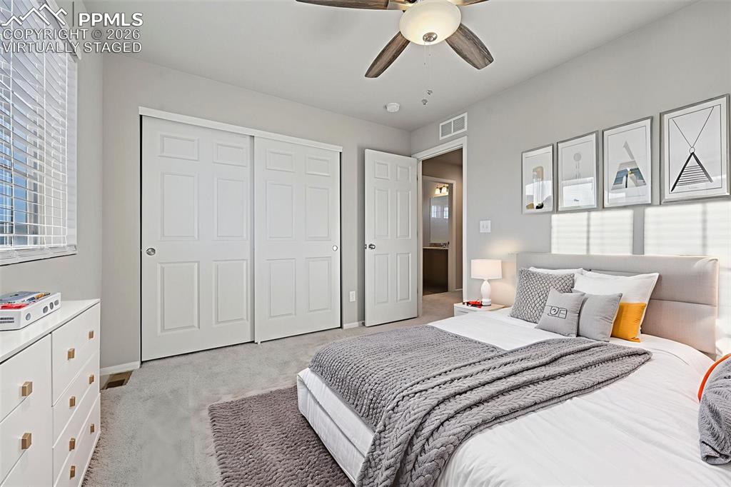 6640 Backcountry Loop Colorado Springs, CO 80927 - Photo 33 of 49 a bedroom with a large bed and chandelier