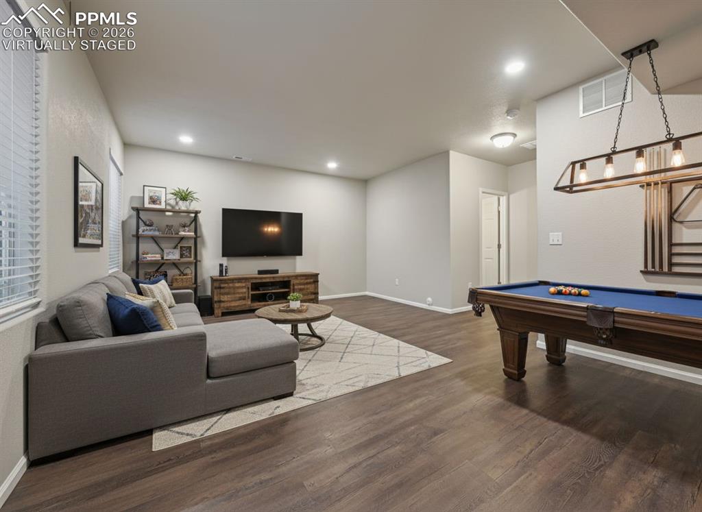6640 Backcountry Loop Colorado Springs, CO 80927 - Photo 36 of 49 a living room with furniture and a flat screen tv