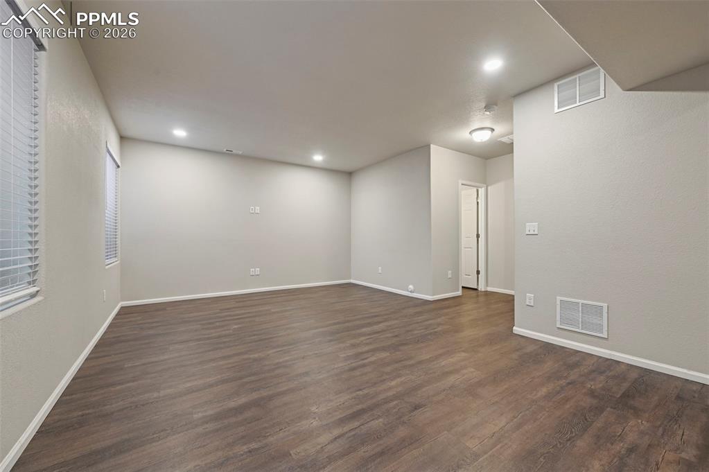 6640 Backcountry Loop Colorado Springs, CO 80927 - Photo 37 of 49 an empty room with wooden floor and windows