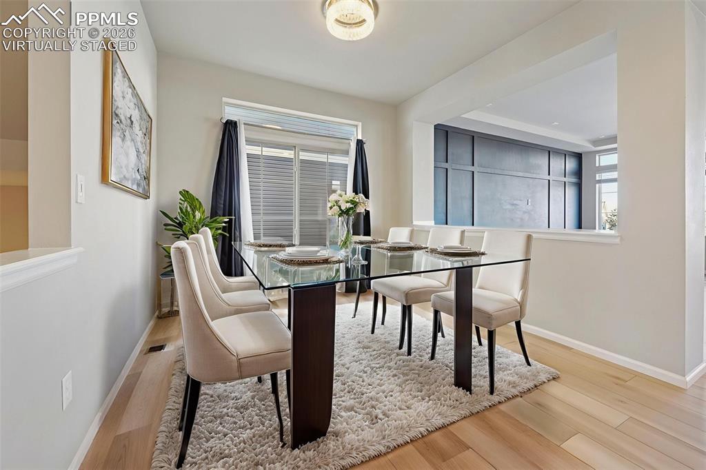 6640 Backcountry Loop Colorado Springs, CO 80927 - Photo 5 of 49 a view of a dining room with furniture and wooden floor
