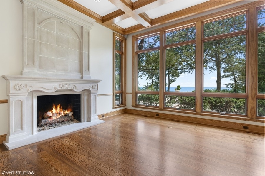 55 Stone Gate Road Lake Forest, IL 60045 - Photo 11 of 62 a view of an empty room with wooden floor and a fireplace