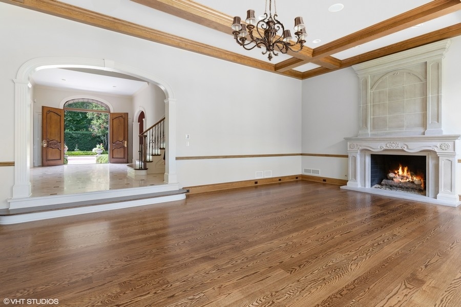 55 Stone Gate Road Lake Forest, IL 60045 - Photo 12 of 62 a view of an empty room with wooden floor and a fireplace