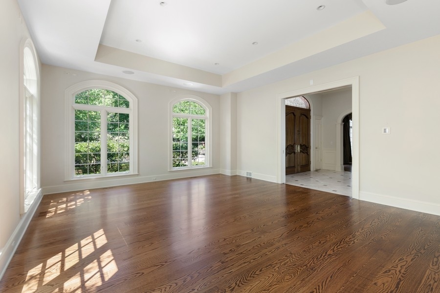 55 Stone Gate Road Lake Forest, IL 60045 - Photo 13 of 62 an empty room with wooden floor and windows
