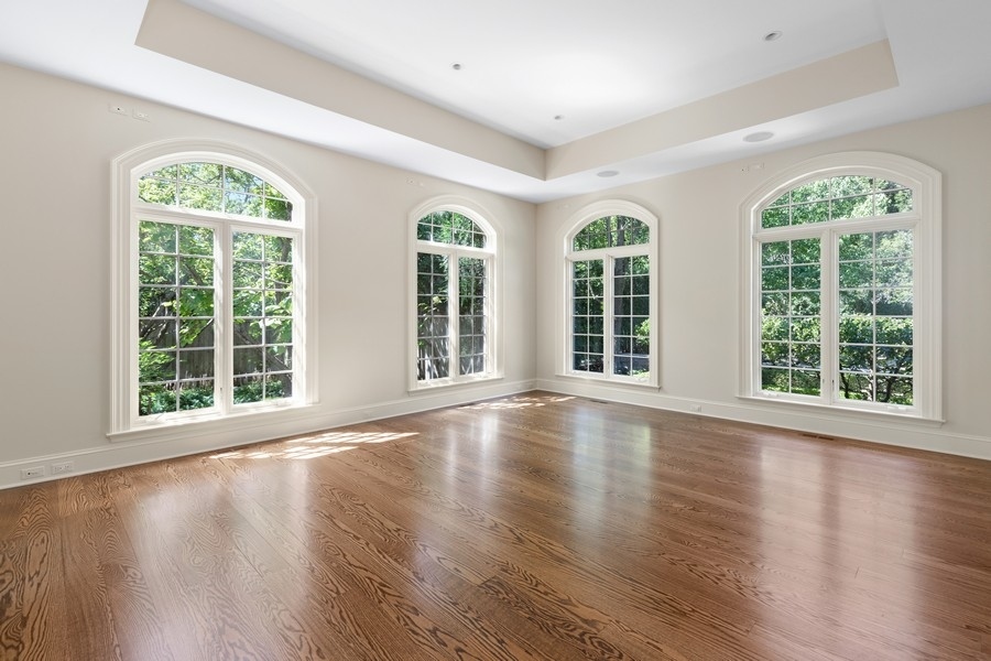 55 Stone Gate Road Lake Forest, IL 60045 - Photo 14 of 62 a view of an empty room with wooden floor and a window