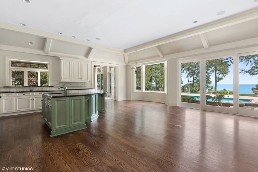 55 Stone Gate Road Lake Forest, IL 60045 - Photo 19 of 62 a kitchen with granite countertop a stove top oven a sink with wooden floors and walls