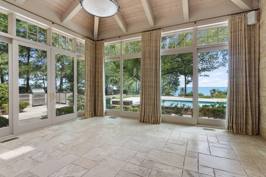 55 Stone Gate Road Lake Forest, IL 60045 - Photo 21 of 62 a room with lots of windows and a chandelier