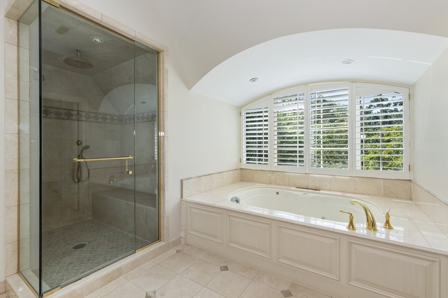 55 Stone Gate Road Lake Forest, IL 60045 - Photo 29 of 62 a spacious bathroom with a bathtub and a shower
