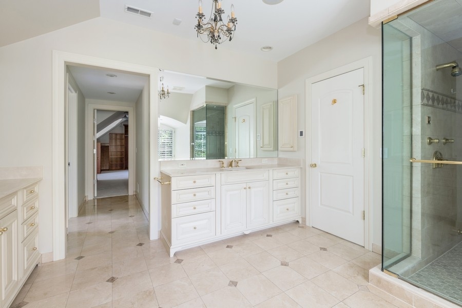 55 Stone Gate Road Lake Forest, IL 60045 - Photo 30 of 62 a spacious bathroom with a double vanity sink and a mirror