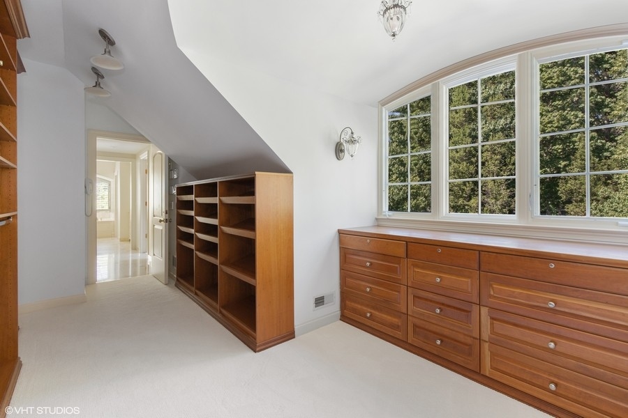 55 Stone Gate Road Lake Forest, IL 60045 - Photo 32 of 62 a view of walk in closet with clothes and shoes