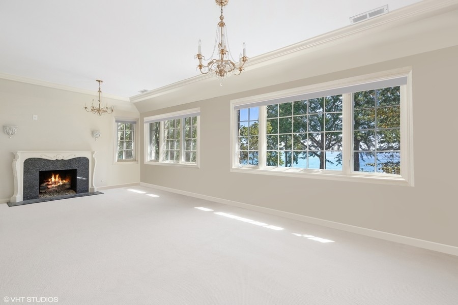 55 Stone Gate Road Lake Forest, IL 60045 - Photo 35 of 62 a view of an empty room with a fireplace and a window