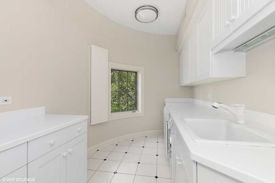 55 Stone Gate Road Lake Forest, IL 60045 - Photo 41 of 62 a utility room with cabinets washer and dryer