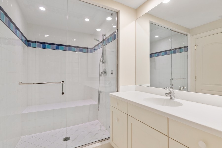 55 Stone Gate Road Lake Forest, IL 60045 - Photo 42 of 62 a bathroom with a shower sink and mirror