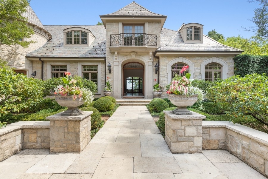 55 Stone Gate Road Lake Forest, IL 60045 - Photo 8 of 62 a front view of a building with potted plants