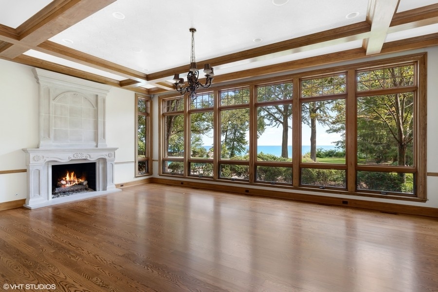 55 Stone Gate Road Lake Forest, IL 60045 - Photo 10 of 62 a view of empty room with wooden floor and fireplace
