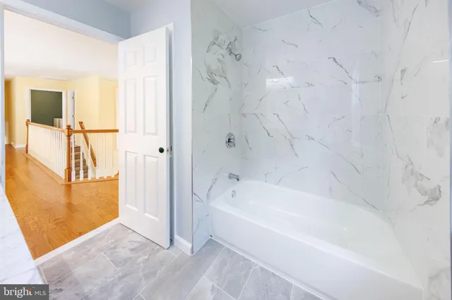 a kitchen with stainless steel appliances granite countertop a refrigerator a sink a stove a microwave and island